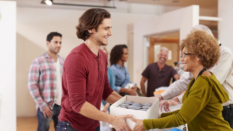 Two people are seen at a food bank | Photo 153624307 © Monkey Business Images | Dreamstime.com